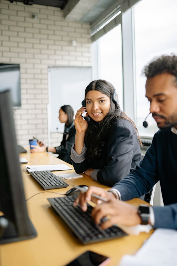 Team of diverse call center agents collaborating efficiently in a modern office.
